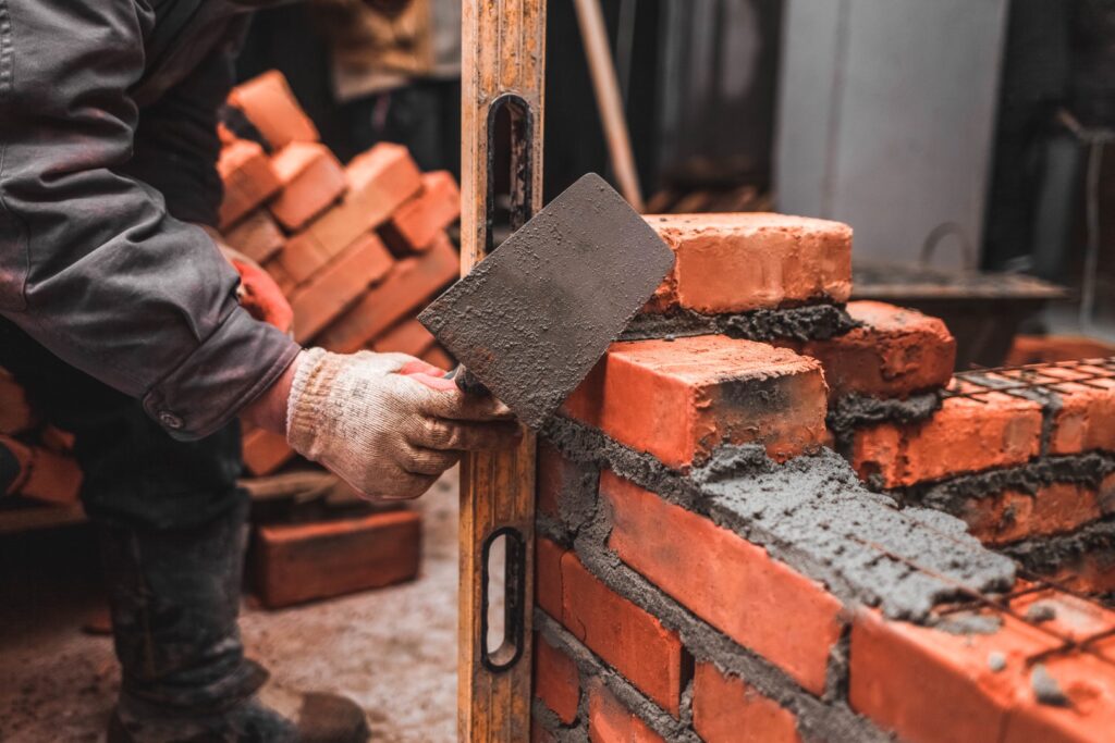 Mason laying brick to build a commercial wall
